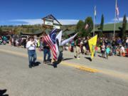 A thumb nail view of Grand Lake, Colorado during Constitution Week in September looking at some of our Veterans carrying flags down Grand Avenue in the Parade; click here to open a window with a larger picture.